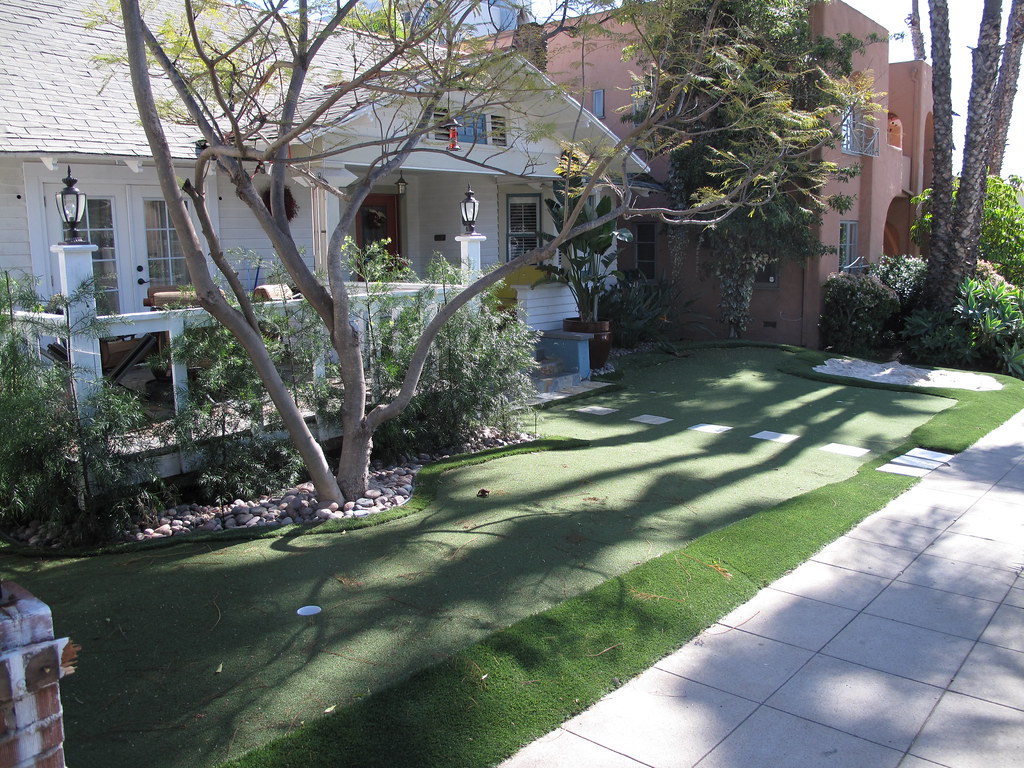 Residential front yard with professionally installed artificial putting green and multiple holes